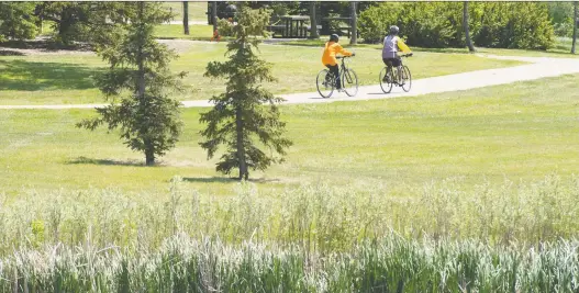  ?? PHOTOS: BRANDON HARDER ?? Bicyclists enjoy the Devonian Pathway in A.E. Wilson Park. “It really, in a lot of ways, defines Regina,” says Mayor Michael Fougere.