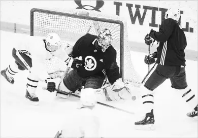  ?? CHRIS YOUNG
THE CANADIAN PRESS ?? Maple Leafs goaltender Frederik Andersen makes a stop against centre Tyler Bozak, right, as centre Tomas Plekanec defends during a practice session in Toronto on Monday as the team prepares for its opening playoff round against the Boston Bruins.