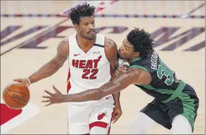  ?? Mike Ehrmann / Getty Images ?? Jimmy Butler, left, and Miami thrive with outside shooting. When Miami shoots better than 31.1 percent for the game, the team is 53-15. When it doesn’t, Miami is 2-17.