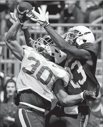  ?? SEAN D. ELLIOT/THE DAY ?? UConn’s Jordan Swann (30) breaks up a pass intended for Keyion Dixon during the Huskies’ annual spring football game on Saturday at Rentschler Field in East Hartford. Visit theday.com to view a photo gallery.