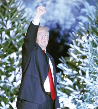  ??  ?? President-elect Donald Trump responds to cheering supporters in front of a backdrop of Christmas trees at a rally in Orlando, Florida on Friday. (AP)