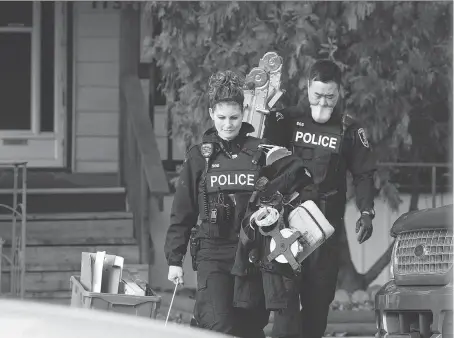  ?? DAX MELMER ?? Windsor police forensics officers investigat­e a shooting Thursday in the 1100 block of Albert Road. Police say the front of a home appeared to be damaged by shots from a small-calibre firearm. Residents say they heard two gunshots, but no injuries were...