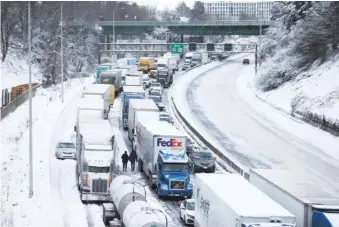 ?? DAVE KILLEN /THE OREGONIAN VIA AP ?? On Thursday, cars and trucks stuck on Interstate 84 are seen from the Blumenauer Bicycle and Pedestrian Bridge in Northeast Portland, Ore.