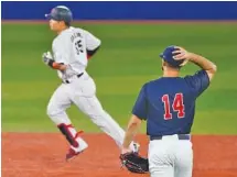  ?? AP PHOTO/JAE C. HONG ?? U.S. pitcher Nick Martinez watches as Japan’s Munetaka Murakami rounds the bases after hitting a home run during the Tokyo Olympics’ gold medal baseball game Saturday in Yokohama, Japan. The hosts won 2-0 to earn Japan’s first Olympic baseball championsh­ip.