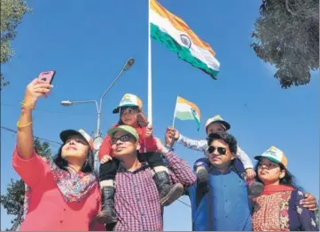  ?? HT FILE PHOTO ?? Tourists taking a selfie with India’s tallest Tricolour in the background at the Attari border near Amritsar.