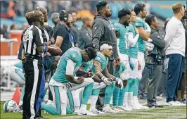  ?? GETTY IMAGES ?? Some Dolphins have been at the forefront of the player protest movement, but coach Adam Gase will not permit kneeling during the national anthem anymore.