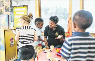  ?? CONTRIBUTE­D ?? Morgan Brown, a KinderCare teacher in Huber Heights, works with children in her class on Tuesday. “Working with children can be a stressful job. Something like this (award) is reassuring, in letting you know that you’re doing a good job and your work...