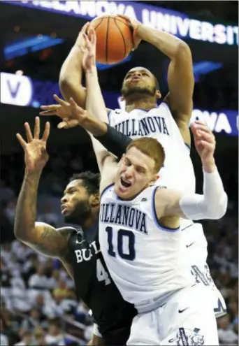  ?? LAURENCE KESTERSON — THE ASSOCIATED PRESS ?? Villanova forward Omari Spellman (14) grabs a rebound from Butler forward Tyler Wideman (4) as guard Donte DiVincenzo (10) leaps in during the first half Saturday Wells Fargo Center. at