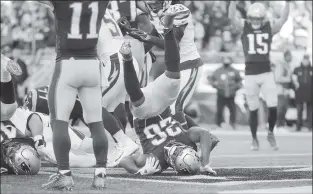  ?? AP PHOTO ?? New England Patriots running back Sony Michel (26) tumbles into the end zone for his third touchdown against the Los Angeles Chargers during the first half of an NFL divisional playoff game Sunday in Foxborough, Mass.