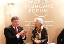  ?? — AFP ?? Christine Lagarde, head of the Internatio­nal Monetary Fund (IMF) meets with Ukrainian President Petro Poroshenko in the Swiss mountain resort of Davos, in this file photo.