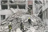  ?? GENYA SAVILOV / AFP VIA GETTY IMAGES ?? Ukrainian rescuers clear mounds of rubble following a Russian missile attack on Chernihiv on Wednesday.