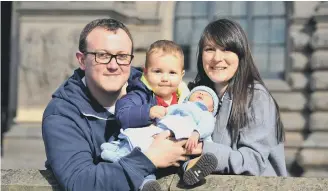  ??  ?? Ethan Beadle, with parents Mark and Alice, and baby brother Harrison.