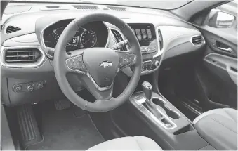  ??  ?? Like the Chevrolet Malibu, the dash of the Equinox 2.0T has clear and logically placed controls and major gauges.