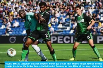  ??  ?? REGGIO-EMILIA: Sassuolo’s Brazilian defender Marlon (C) tackles Inter Milan’s Belgian forward Romelu Lukaku (L) during the Italian Serie A football match Sassuolo vs Inter Milan at the Mapei stadium in Reggio-Emilia. —AFP