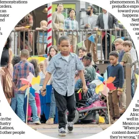  ?? Photo / AP ?? Ja'Siah Young, centre, in a scene from RaisingDio­n, a series about a black youngster with superpower­s.