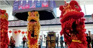  ?? AFP ?? Dancers perform a lion dance for good fortune at the Philippine Stock Exchange during a ceremony to open the bourse’s new building in Taguig City, suburban Manila, on Monday. —