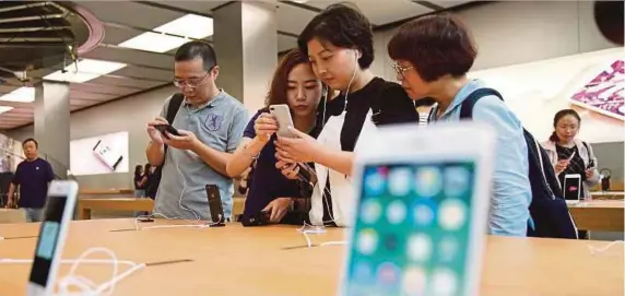  ?? [ FOTO REUTERS] ?? Pelanggan melihat iphone 8 di Apple Store Shanghai, China sempena pelancaran model itu, semalam.
