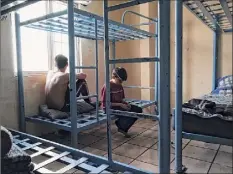  ?? Kevin Sieff / Washington Post News Service ?? Migrant children detained at the U.s.-mexico border sit in the dormitory of the Center for Attention to Border Minors in Reynosa, Mexico. Carlos, 15, left, fled cartels in Mexico. Joshua, 13, left El Salvador to join his mother in Maryland.