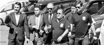  ??  ?? Brazilian Olympic Committee (COB) President Carlos Arthur Nuzman (centre) arrives to Federal Police headquarte­rs in Rio de Janeiro, Brazil in this Sept 5 file photo. — Reuters photo