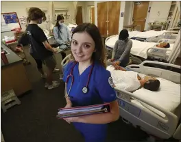  ?? GARY KAZANJIAN — THE ASSOCIATED PRESS ?? Nursing student Emma Champlin in her clinical laboratory class at Fresno State in Fresno on Wednesday.