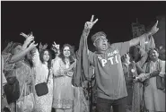  ?? AP/SHAKIL ADIL ?? Supporters of politician Imran Khan, chief of the Pakistan Tehreek-e-Insaf party, celebrate Khan’s parliament­ary victory Thursday in Karachi.