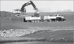  ?? Herald photo by Ian Martens ?? An excavation crew works on the Malloy Drain project wetlands and stormwater retention pond in the area of the proposed Centennial Park, new high school and multi-use recreation facility, as part of Coaldale’s recently approved capital plan. @IMartensHe­rald