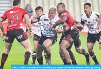  ??  ?? CHRISTCHUR­CH: Sunwolves’ Hosea Saumaki (C) is tackled by Crusaders’ Manasa Mataele (R) during the Super Rugby match between the Canterbury Crusaders of New Zealand and the Sunwolves of Japan in Christchur­ch yesterday. —AFP