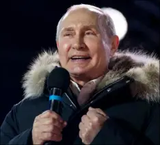  ??  ?? Russian President Vladimir Putin speaks to supporters during a rally near the Kremlin in Moscow, Sunday. AP PHOTO/ALEXANDER ZEMLIANICH­ENKO