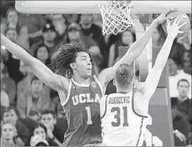  ?? Mark J. Terrill Associated Press ?? MOSES BROWN, the UCLA freshman center defending USC’s Nick Rakocevic, might be the only Bruin who could sneak into the first round of the NBA draft.