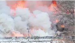  ?? AFP ?? Firefighte­rs try to extinguish a fire at the Guryong village, one of South Korea’s last remaining slums, in southern Seoul yesterday.