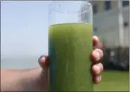  ?? HARAZ N. GHANBARI — THE ASSOCIATED PRESS FILE ?? A sample glass of Lake Erie water is photograph­ed near the city of Toledo water intake crib on Lake Erie, off the shore of Curtice.