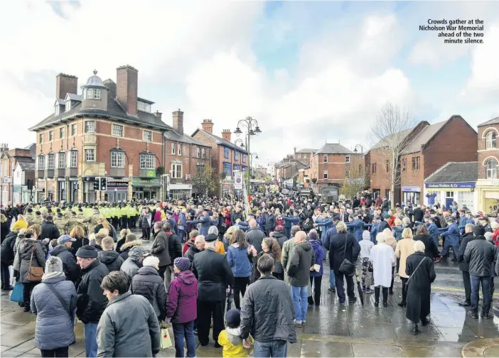  ??  ?? Crowds gather at the Nicholson War Memorial ahead of the two minute silence.