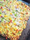  ?? GRETCHEN MCKAY/ PITTSBURGH POST-GAZETTE ?? This vegetarian pizza is made with shredded zucchini, mozzarella and Parmesan cheeses and egg.