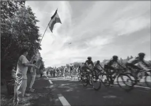  ?? The Associated Press ?? CHEERING SECTION: Spectators cheer as the pack passes during the fifth stage of the Tour de France cycling race over 160.5 kilometers (99.7 miles) Wednesday.