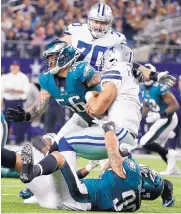  ?? MICHAEL AINSWORTH/ASSOCIATED PRESS ?? Philadelph­ia’s Chris Long (56) and Derek Barnett (96) sack Dallas quarterbac­k Dak Prescott during Sunday’s game. Prescott threw three intercepti­ons in the Cowboys’ 37-9 loss.