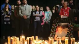  ??  ?? A picture of Niccolai Schuster is placed at a memorial during a vigil on Wednesday for the victims of the Berkeley balcony collapse.