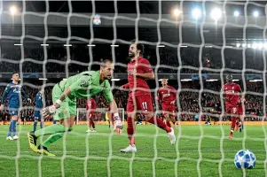  ?? GETTY IMAGES ?? Mohamed Salah scores Liverpool’s third goal from the penalty spot against Red Star Belgrade during a Champions League match at Anfield.