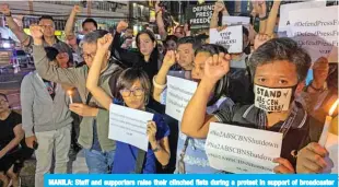  ??  ?? MANILA: Staff and supporters raise their clinched fists during a protest in support of broadcaste­r ABS-CBN in Manila yesterday. — AFP