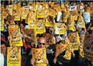  ?? THE ASSOCIATED PRESS ?? Demonstrat­ors holding banners that read in Catalan: “Freedom for the Political Prisoners,” gather Sunday during a protest against the decision of a judge to jail ex-members of the Catalan government.