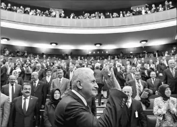  ?? — Reuters photos ?? Turkey’s Prime Minister Binali Yildirim greets members of parliament from his ruling AK Party (AKP) as he arrives for a meeting at the Turkish parliament in Ankara on Apr 18.