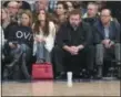  ?? MARY ALTAFFER — THE ASSOCIATED PRESS ?? Madison Square Garden chairman James Dolan, center, and actress Katie Holmes watch during the first half of an NBA basketball game between the New York Knicks and the Denver Nuggets, Friday at Madison Square Garden in New York.