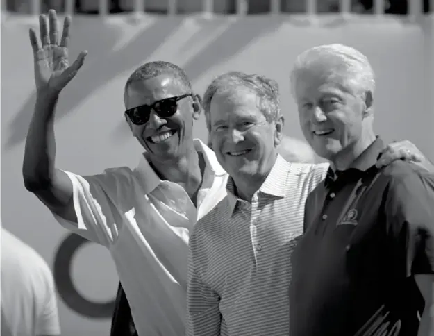  ??  ?? Former U.S. Presidents, from left, Barack Obama, George Bush and Bill Clinton greet spectators on the first tee before the first round of the Presidents Cup at Liberty National Golf Club in Jersey City, N.J., Thursday, Sept. 28, 2017. (AP)