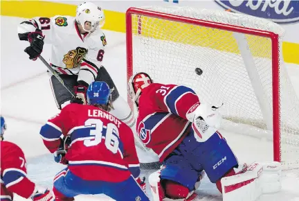  ?? ALLEN MCINNIS/MONTREAL GAZETTE ?? Canadiens goalie Carey Price looks back at the net as Chicago Blackhawks forward Garrett Ross scores during a pre-season game in Montreal on Friday. The Blackhawks, resting plenty of big names, routed the uninspired Habs 5-1.