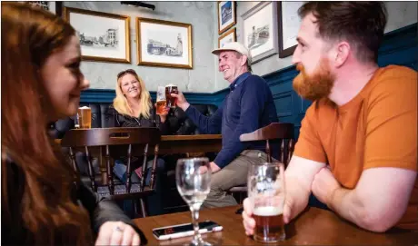  ?? Picture: Jane Barlow ?? Customers enjoy a drink inside an Edinburgh pub after the latest round of lockdown easing came into force across most of Scotland