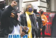  ??  ?? Longtime social justice activist Angela Davis (center) attends the May Day demonstrat­ion in S.F.