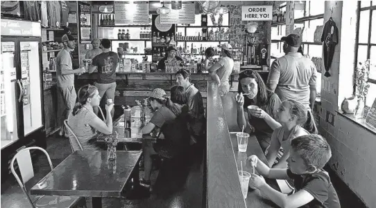  ?? LORI RACKL/CHICAGO TRIBUNE ?? Lexington’s Distillery District is home to Crank &amp; Boom Ice Cream Lounge, a fun spot to indulge in frosty treats like bourbon and honey ice cream.