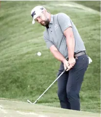  ??  ?? CLOSE. Ryan Moore chips onto the ninth green during the first round of The Players Championsh­ip. Moore finished at 5-under and is tied for fifth with two others.