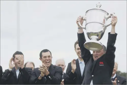  ?? Picture: Getty Images ?? Victorious Great Britain & Ireland captain Nigel Edwards lifts the Walker Cup at Royal Aberdeen Golf Club in 2011