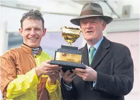  ?? ?? Jockey Paul Townend and trainer Willie Mullins lift the Gold Cup.