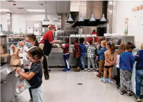  ?? New York Times file photo ?? Students go through a lunch line in 2021 at Rising Hill Elementary in Kansas City, Mo. A new proposal would limit sugar and sodium in school meals.